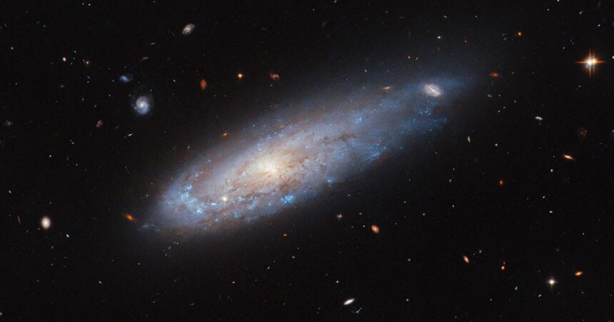 Hubble Telescope Captures Spiral Galaxy Racing Through Crowded Cluster